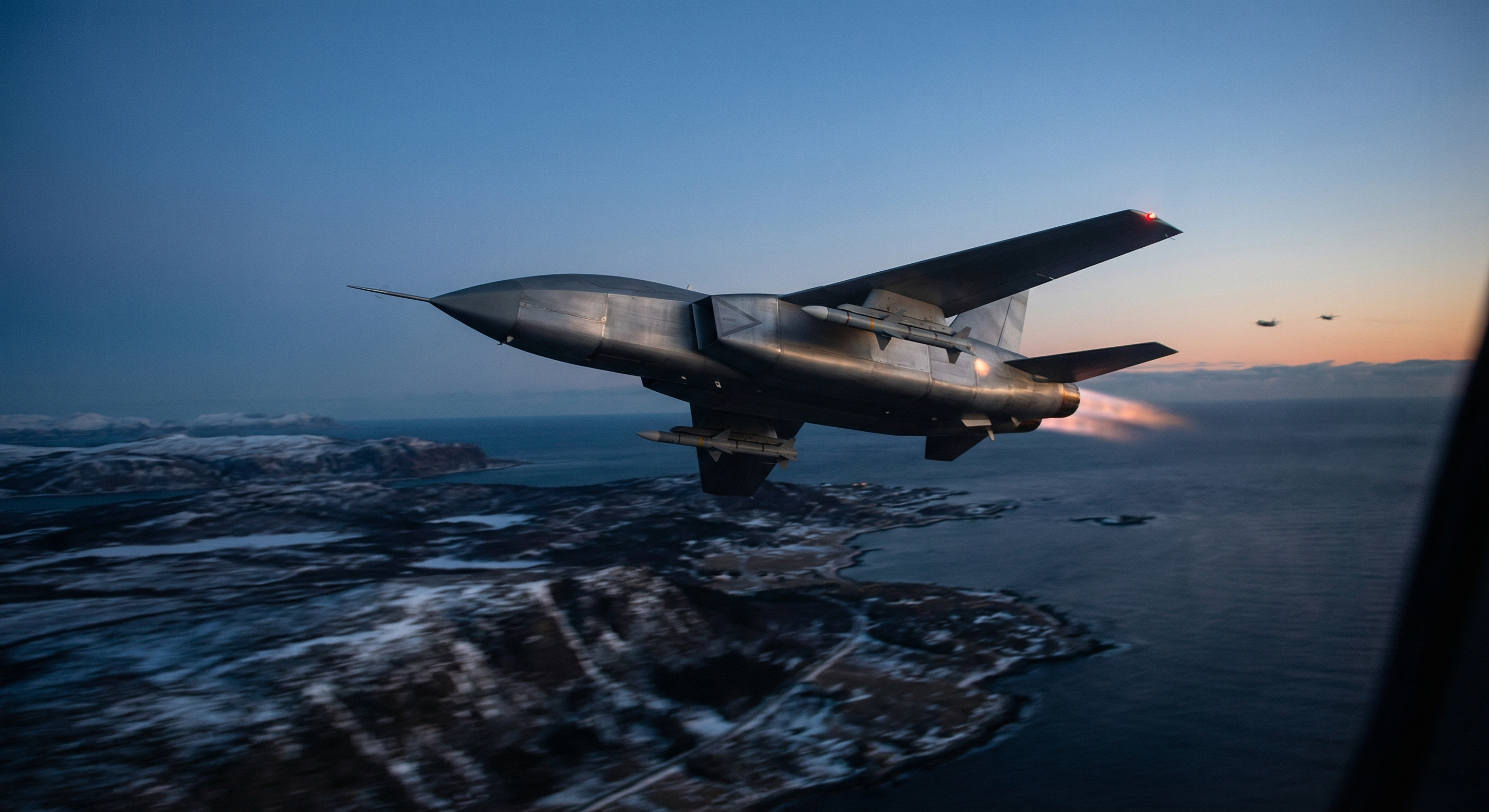 A jet-powered unmanned interceptor drone with swept wings and missiles flying over a dark northern European landscape at dusk