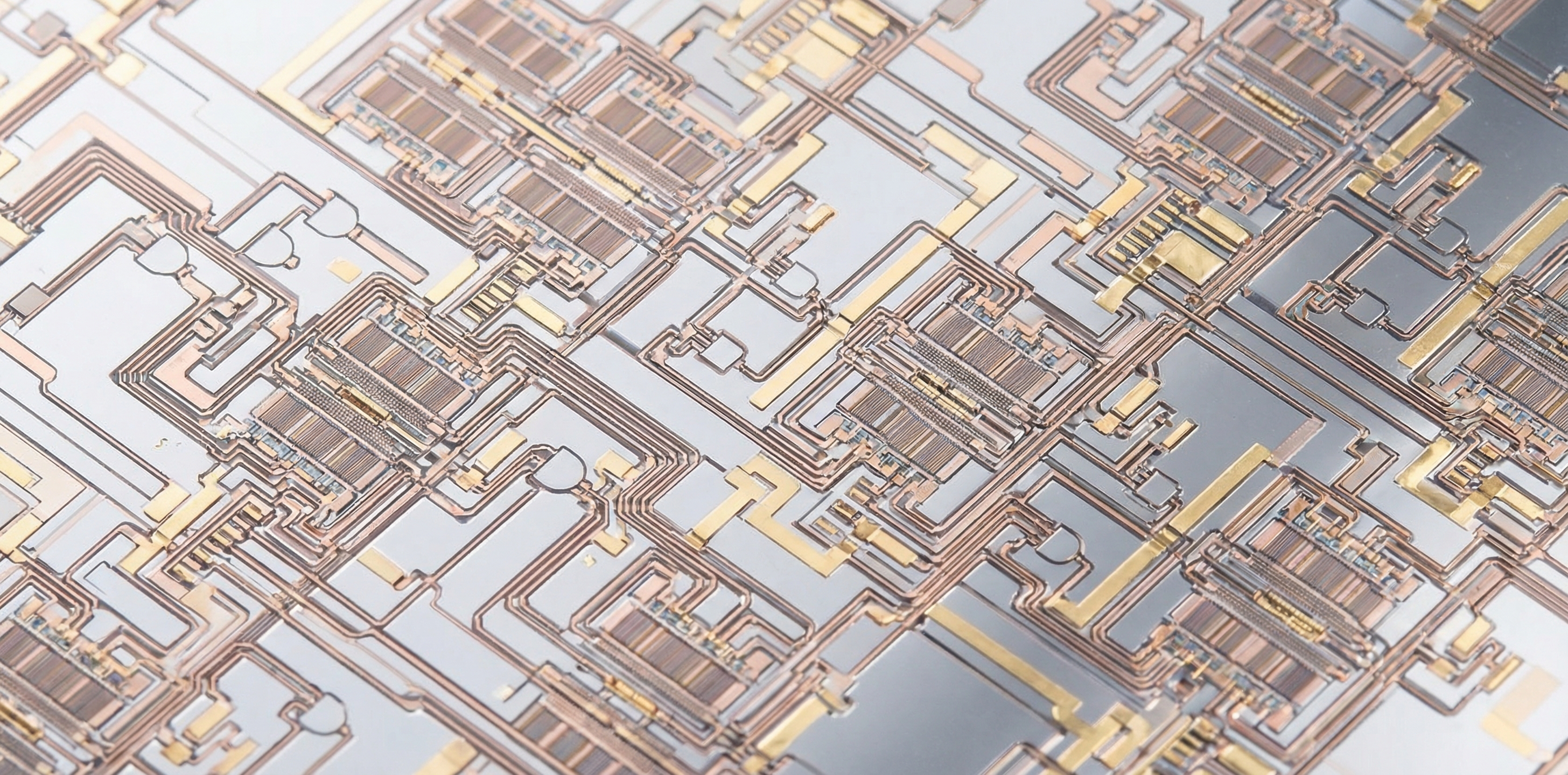 Rows of advanced semiconductor wafers with intricate circuit patterns under precision industrial lighting in a high-technology chip fabrication facility
